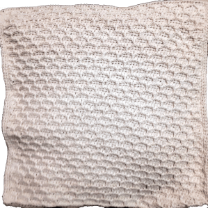 The front section made for a cream-colored pillow cover with a clever honeycomb stitch pattern, showcasing a textured design.